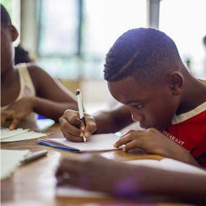 Young boy writing in journal