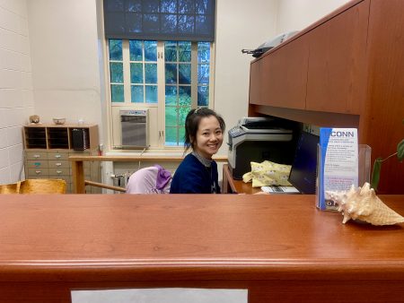 graduate assistant sitting at undergraduate advising office desk