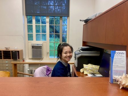 Graduate assistant sitting at undergraduate Advising Office desk